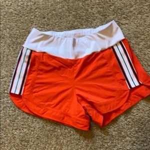 Bright orange Athleta running shorts